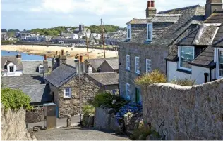  ??  ?? Steep narrow lanes wind down through stepped buildings to the sea’s edge (above).