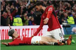  ?? (Molly Darlington/Reuters) ?? MANCHESTER UNITED teammates Alejandro Garnacho (left) and Bruno Fernandes celebrate after Amad Diallo scored the Red Devils’ fourth goal during extra time of their dramatic 4-3 FA Cup quarterfin­al victory over Liverpool last night at Old Trafford.