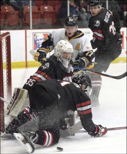  ?? TRURO DAILY NEWS PHOTO ?? The traffic was heavy in front of the Truro net during MHL action Saturday at the RECC where the Bearcats defeated the visiting Yarmouth Mariners 3-1. Jagger Statton of the Bearcats is attempting to clear the puck in front of netminder Alec Macdonald...