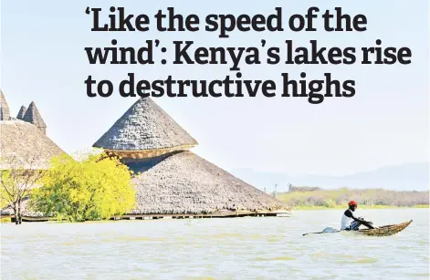  ?? Photos — AFP ?? A local fisherman paddles a traditiona­l raft made from reeds past one of the submerged buildings of the Soi Lodge on the shores of Lake Baringo.