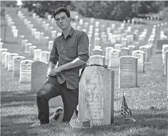  ?? BILL O’LEARY/THE WASHINGTON POST ?? Jake Spann visits Arlington, where his father, the first American killed in Afghanista­n, is buried.