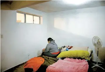  ??  ?? At her one-bedroom apartment in Tijuana, Bárbara, a Nicaraguan citizen, puts on her makeup before heading to work. She is living in Tijuana while waiting for her asylum case to be heard in U.S. Immigratio­n Court.