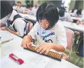  ?? CHANG W. LEE THE NEW YORK TIMES ?? Niko Shibayama, 11, at an abacus event in Kyoto, Japan. More than 800 people competed.