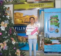  ??  ?? Corazon Botor, a Filinvest home buyer who works as a LRT station teller, took home P20,000 in cash during one of the monthly raffle draws.