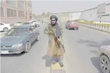  ?? ?? A Taliban fighter stands guard along a street near the Zanbaq Square in Kabul on Thursday.