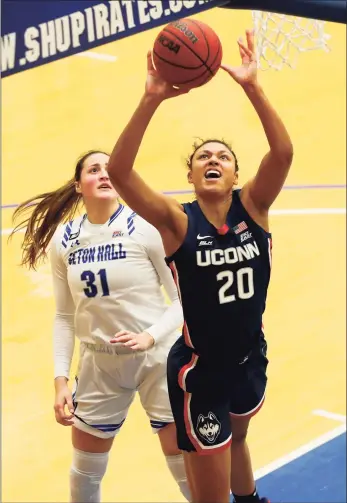  ?? Noah K. Murray / Associated Press ?? UConn’s Olivia Nelson-Ododa (20) goes to the basket against Seton Hall forward Alexia Allesch during a game earlier this season.