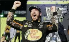  ?? TERRY RENNA — THE ASSOCIATED PRESS ?? Martin Truex Jr. celebrates in Victory Lane after winning the race and season championsh­ip in Homestead, Fla., on Sunday.