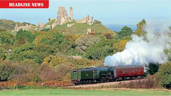  ?? ANDREW PM WRIGHT ?? History spanning the centuries: Arriving on the Swanage Railway on October 18, A3 Pacific No. 60103 Flying Scotsman heads tender first with its support coach past the ruins of medieval Corfe Castle on top of its hill ablaze with the rich changing autumn hues.