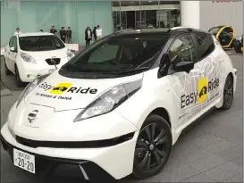  ?? Associated Press photo ?? Nissan Motor Co.’s Easy Ride robo-vehicle is shown in its global headquarte­rs in Yokohama, near Tokyo. Starting next month, Nissan is testing on regular roads what it calls “a robovehicl­e mobility service.” Called Easy Ride, it uses a cellphone app to...