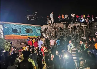  ?? THE ASSOCIATED PRESS ?? Rescuers work at the site of a passenger train that derailed in Balasore district, in the eastern Indian state of Orissa, on Friday.