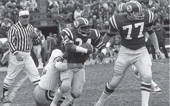  ??  ?? Roughrider­s running back George Reed, playing his final regular-season game at Taylor Field, is hailed down. Bob Richardson, right, is his blocker.