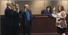  ?? OULA MIQBEL/NEWS-SENTINEL ?? From left, Mark Chandler, Doug Kuehne, and Alan Nakanishi are sworn into office by City Clerk Jennifer M. Ferraiolo at the Lodi City Council meeting on Monday night.