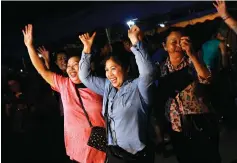  ?? Sakchai Lalit/Associated Press ?? ■ People celebrate Tuesday after divers evacuated some of the 12 boys and their coach trapped at Tham Luang cave in the Mae Sai district of Chiang Rai province, northern Thailand. Thai Navy SEALs say all 12 boys and their coach were rescued from the...