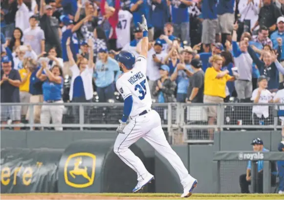  ?? Ed Zurga, Getty Images ?? Eric Hosmer of the Kansas City Royals celebrates his game-winning, three-run homer in the ninth inning Wednesday night against the Rockies.