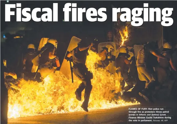  ?? Pictures: AP, AFP ?? FLAMES OF FURY: Riot police run through fire as protesters throw petrol bombs in Athens and ( below) Greek Finance Minister Euclid Tsakalotos duringg the vote in parliament. .