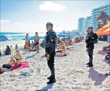  ?? AFP/Getty Images ?? FEDERAL POLICE patrol in Cancun, Mexico, last year after a shooting thought to be linked to drug sales. Mexico’s tourism secretary this week said the country should consider marijuana legalizati­on, starting in the states home to the resorts of Cancun...