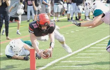  ?? Jenn March / Special to the Times Union ?? Glens Falls running back Griffin Woodell stretches the ball for a touchdown against Schalmont. He has 18 touchdowns and 1,048 yards on the season.