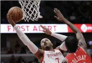  ?? NAM Y. HUH - THE ASSOCIATED PRESS ?? FILE - In this Nov. 3, 2018, file photo, Houston Rockets forward Carmelo Anthony, left, drives to the basket against Chicago Bulls forward Justin Holiday during the first half of an NBA basketball game in Chicago.