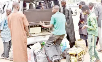  ?? ?? A driver negotiates price with passengers at Zuba Motor Park in Abuja
yesterday
