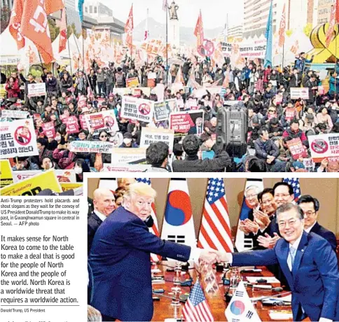  ??  ?? Anti-Trump protesters hold placards and shout slogans as they wait for the convoy of US President DonaldTrum­p to make its way past, in Gwanghwamu­n square in central in Seoul. — AFP photo Trump (left) and Moon shake hands before their summit meeting at...