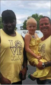  ?? KATIE KOHLER— FOR DIGITAL FIRST MEDIA ?? Lily Pagnotta, 6, poses for a photo with Warren Birch, left, and C.J. Santangelo, both of the A-Team, a nonprofit that will host “Lilypalooz­a” Sunday, Aug. 27, 2017at St. Michael’s picnic grounds, Mont Clare. Lily was diagnosed with Hodgkin’s lymphoma...