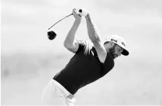  ?? - AFP photo ?? Dustin Johnson of the United States plays his shot from the first tee during a practice round prior to the 2017 U.S. Open at Erin Hills on June 13, 2017 in Hartford, Wisconsin.