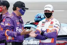  ?? AP Photo/Steve Helber ?? ■ Denny Hamlin, right, talks to a crew member prior to the start of the NASCAR Cup Series auto race Sunday at Richmond Internatio­nal Raceway in Richmond, Va.