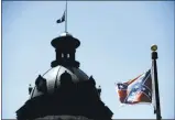  ?? RAINIER ERHARDT/ASSOCIATED PRESS ?? A Confederat­e flag flies on the grounds of the South Carolina Statehouse in Columbia. The flag was moved from the dome after a compromise in 2000.