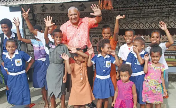  ??  ?? Prime Minister Voreqe Bainimaram­a with children from Tokou Village in Levuka on July 15, 2020.