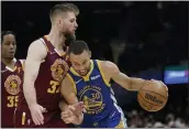  ?? ?? The Warriors’ Stephen Curry drives against the Cavaliers’ Dean Wade in the second half on Thursday.