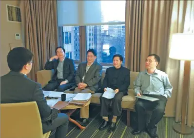  ?? PROVIDED TO CHINA DAILY ?? Chen Xinyuan, vice-president of Shanghai University of Finance and Economics (second from right), and Tian Guoqiang, director of the university’s School of Economics (second from left), interview a job applicant on the sidelines of the Allied Social...