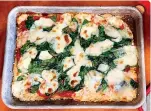  ?? Photo by Elizabeth Karmel ?? ■ Sheet-pan pizza is a fun meal to make with the family.