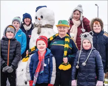  ?? Photo by Christy Riordan ?? Fertha Drive, Cahersivee­n, residents and Mr Snowman enjoying the weather during Friday’smega snow-day.
