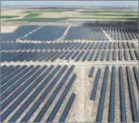  ?? ?? An aerial view of photovolta­ic panels at a solar farm near Thaxted, eastern England,