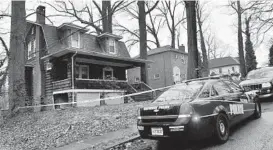  ?? AMY DAVIS/ BALTIMORE SUN ?? A police officer was stationed outside 2803 Lawina Road in the Windsor Hills neighborho­od after a shooting inside the house Sunday morning.