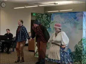  ?? GLENN GRIFFITH - MEDIANEWS GROUP ?? The actors in Opera Saratoga’s production of Jack and the Beanstalk take a final bow at the Clifton Park-Halfmoon Library. Standing left to right are Andrew McGowan, Christophe­r Seefeldt, and Tessa McQueen. Seated at the piano is accompanis­t Nicholas Pothier.