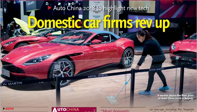  ?? Photo: AFP ?? A worker cleans the floor prior to Auto China 2018 in Beijing.