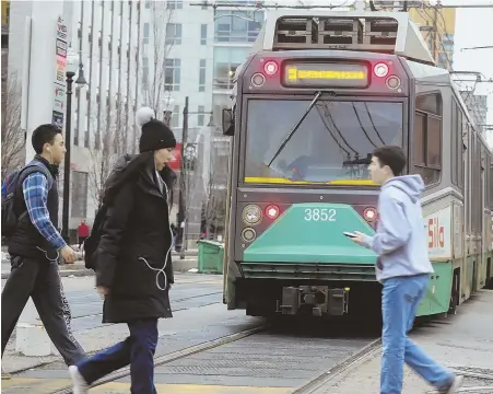  ?? COURTESY PHOTO, RIGHT, BOSTON FIRE DEPARTMENT; STAFF PHOTO BY NICOLAUS CZARNECKI ?? ‘RED LEVEL’: A Green Line train near the Kenmore Station derailed in March 2014. A train, below, makes its way along Huntington Avenue on the E Line yesterday.