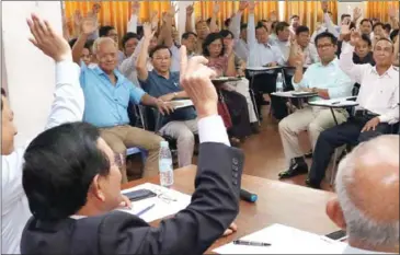  ?? FACEBOOK ?? CNRP members vote in favour of the party’s re-selection of three deputy presidents at a closed-door meeting yesterday in Phnom Penh.