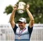  ?? JOSEPH SCHELLER / THE MORNING CALL ?? Padraig Harrington with the Francis D. Ouimet Memorial Trophy for the U.S. Senior Open.