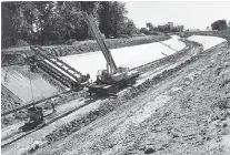  ?? Windsor Star files ?? Crews pour concrete along the Grand Marais Drain east of Huron Church Road in August 1971. The city and ERCA have launched a
$1.1-million improvemen­t project to improve the storm drain.