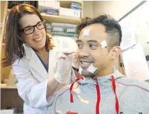  ?? DARREN MAKOWICHUK ?? Researcher Amy Bender works with her client, Olympic speedskate­r Gilmore Junio, who has suffered from sleep apnea.