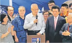  ??  ?? Wu (centre) speaks during a news conference in Taipei. — Reuters photo