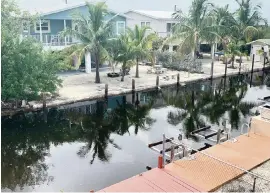  ?? JENNIFER BARR LEFELAR For the Miami Herald ?? High tides in the Florida Keys sent canals up to the docks in Big Pine Key on Aug. 2, 2019. Monroe County said it won’t go forward with a climate-mitigation project if the Army Corps of Engineers insists on mandatory buyouts.