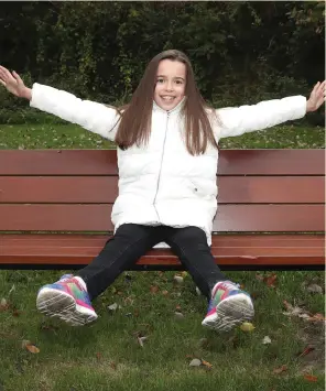  ??  ?? Alexandra Hope sits on a bench in the 1916 memorial garden in Drogheda which is dedicated to the memory of her Grandfathe­r Eugene Byrne and his fellow garden club member Peggy O’Reilly.