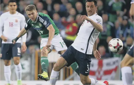  ??  ?? Jamie Ward slams home Northern Ireland’s early opener in last night’s clash with Norway at Windsor Park