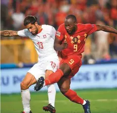  ?? AFP ?? Belgium’s Romelu Lukaku (right) scores a goal during his team’s 2-1 victory against Switzerlan­d.