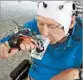  ?? MARIO CORTESE ?? A patient with a spinal-cord injury uses a mind-controlled robotic hand to drink from a cup in Badalona, Spain.