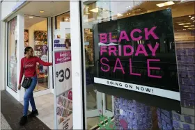  ?? PHOTOS BY REBECCA BLACKWELL — THE ASSOCIATED PRESS ?? Shoppers exit a Claire’s accessorie­s store advertisin­g sales ahead of Black Friday and the Thanksgivi­ng holiday, Monday, in Miami.