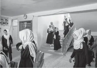  ?? Kiana Hayeri / New York Times ?? Girls attend school in Sheberghan, Afghanista­n, in May. The war in Afghanista­n has cost the lives of more than 2,400 U.S. troops and as much as $2 trillion.